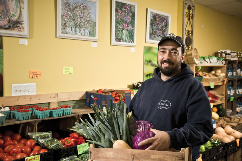 Tom Coates, owner of The Local Market in Falls Church, sells fresh produce, meats, organic dairy products and specialty items from area farms and food entrepreneurs. Photo by  Benjamin C. Tankersley