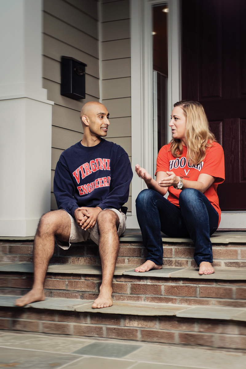 Sunny DiSoco sits on the steps of his home near Washington-Lee High School with fellow Arlingtonian Aubyn Carraway. Carraway was the recipient of his “Ideal Scholarship” at U.Va. four years in a row. She graduated in 2011 and now works as a senior marketing analyst. Photo by Erick Gibson