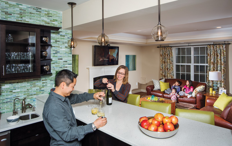 Phong and Carrie Le’s swanky basement bar features dark Kemper cabinets and Caesarstone countertops. Photo by Darren S. Higgins