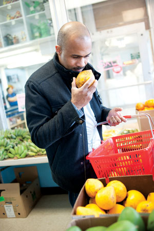 Morou Ouattara of Kora and Farrah Olivia shops for fresh ingredients at Eden Center. Photo by Michael Ventura